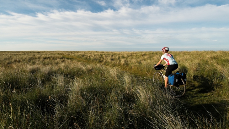 Woman cycling on Coast and Castles route
