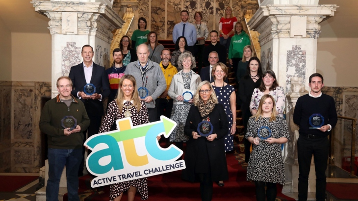 Group photo of winners and partners on staircase of Belfast City Hall