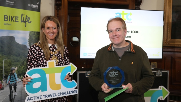 Man collecting award from Belfast Lord Mayor