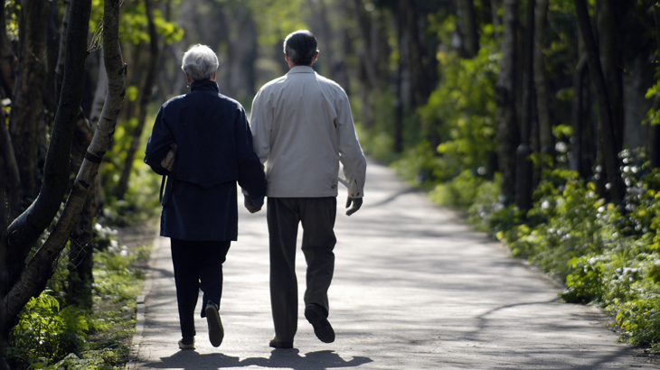 An elderly couple take a stroll along the National Cycle Network on a sunny day.