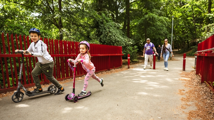 Family out using their scooters on Dodder Greenway