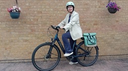 Woman wearing helmet on ebike in Derry