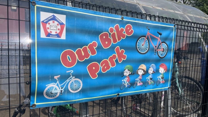 Cycle storage at Ballymena Primary with poster saying 'Our Bike Park'