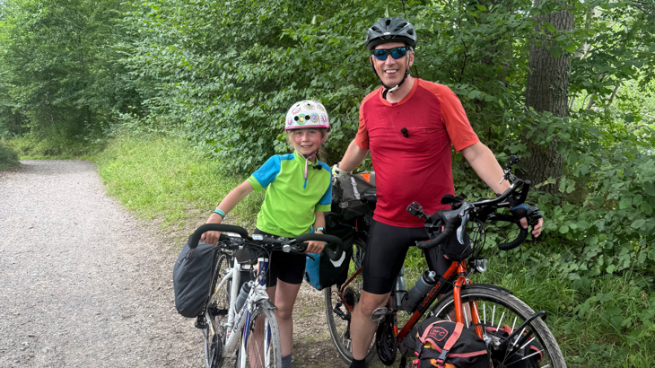 Ian and his daughter Iona stand with their touring bikes on the Avenue Verte cycle path.