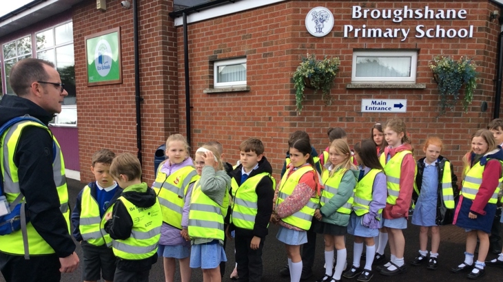 Johnny McCrystal, Project Officer at work with pupils wearing hi-vis from Broughshane Primary in Co Antrim